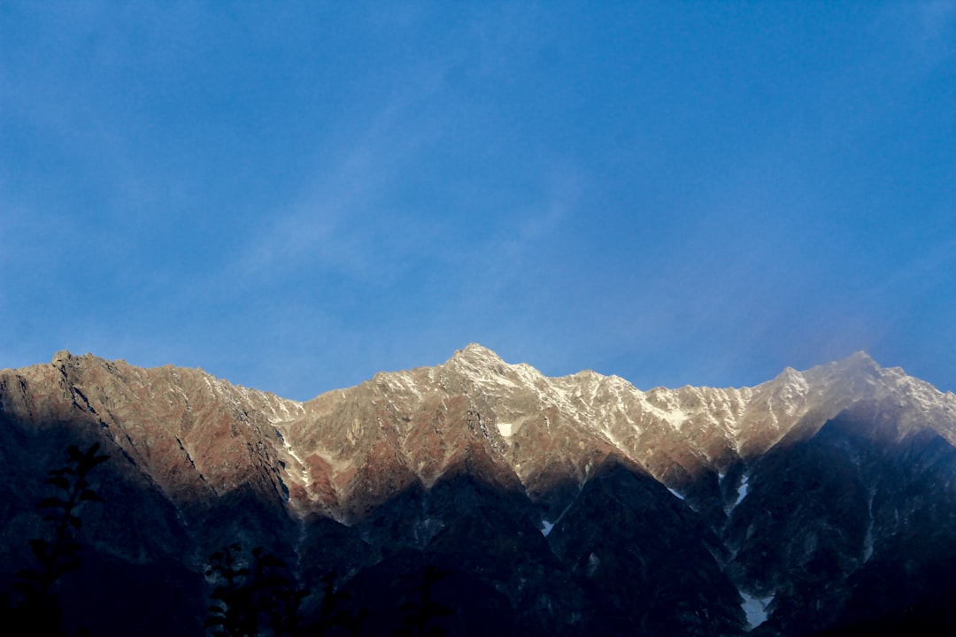 snow covered mountain under blue sky during daytime