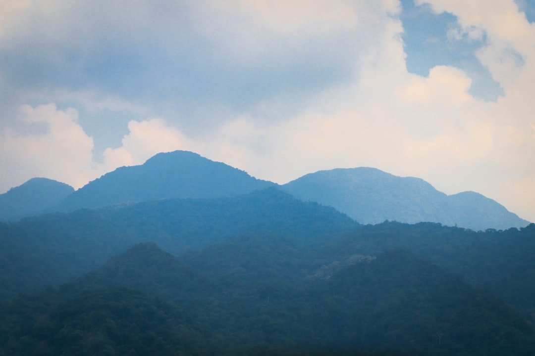 green mountains under white clouds during daytime